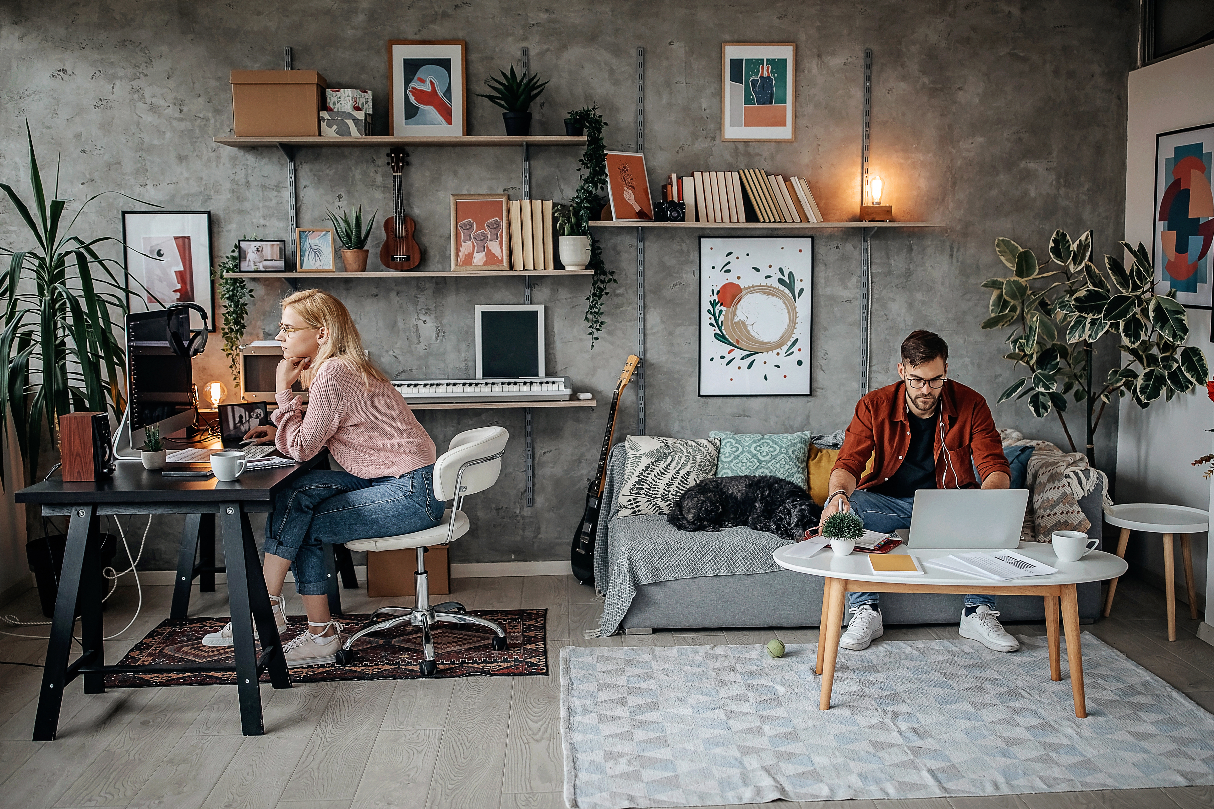 Couple working from home in a room that is far too small for both of them | First Alliance Credit Union