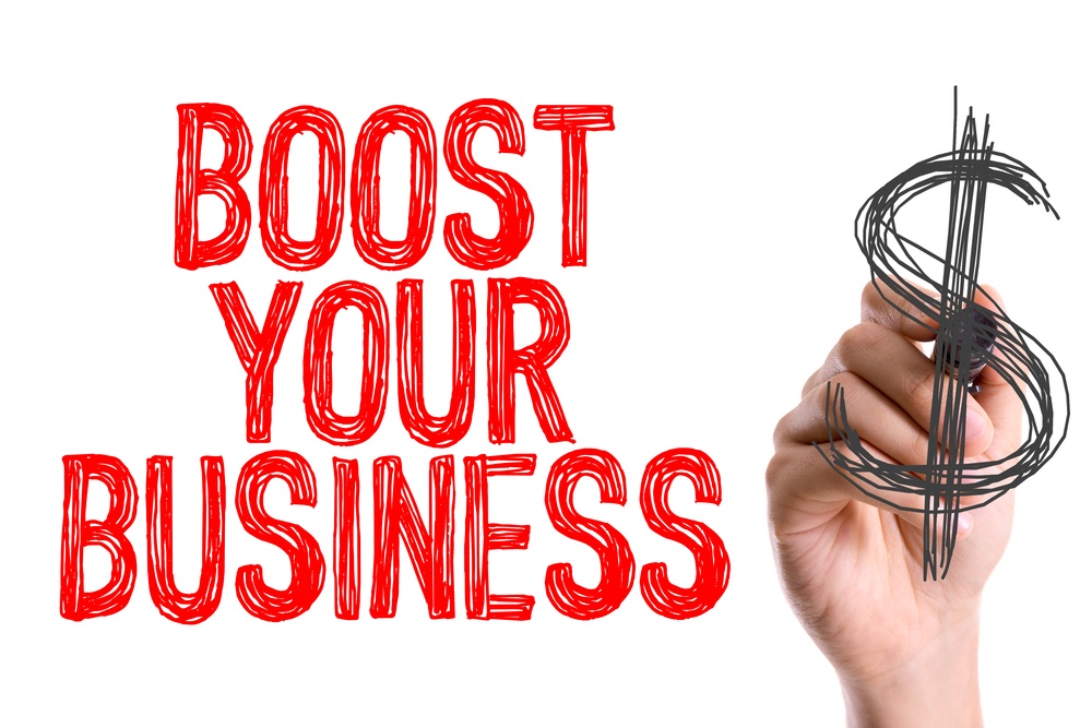 Hand with marker writing Boost Your Business.jpeg