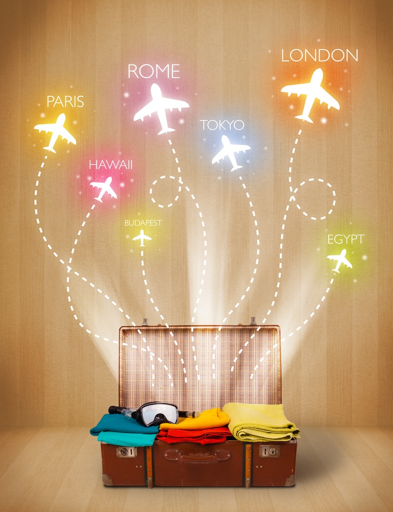 Travel bag with clothes and colorful planes flying out on grungy background.jpeg