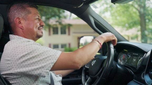 Roberto driving a company car