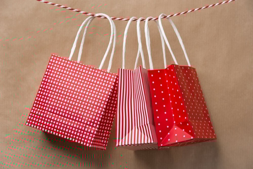 Red gift bags hanging from a string