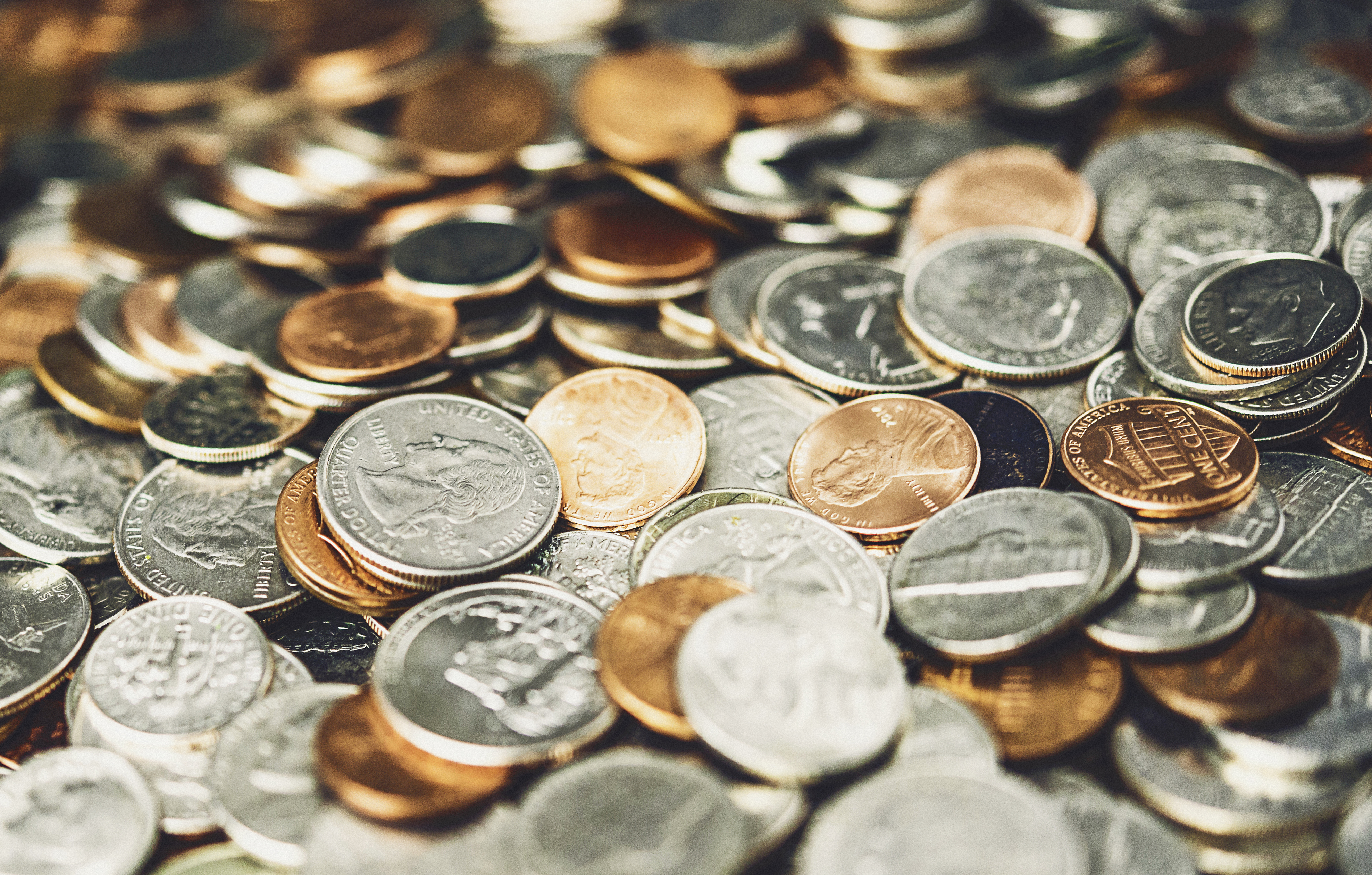 coins waiting to be deposited into a coin machine at first alliance credit union